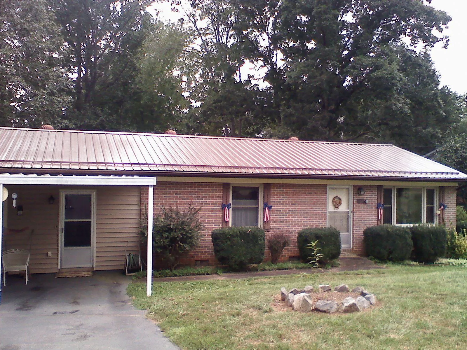 Bronze metal roof and carport on a brick ranch home — Roof Repair work by our crew in Shrub Oak
